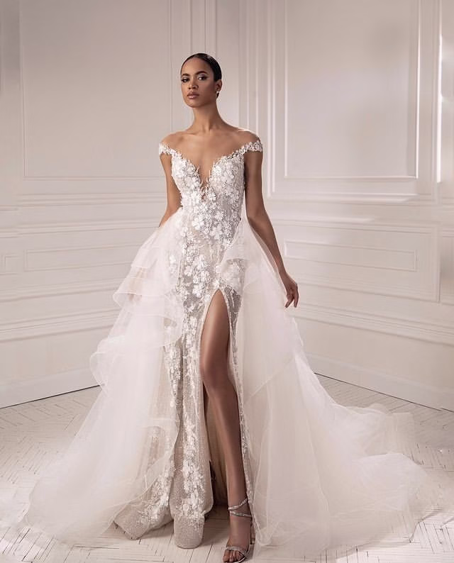 Bridal stylist assisting client fitting dress